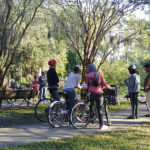 Riverkeeper education team biking with members along McCoys Creek