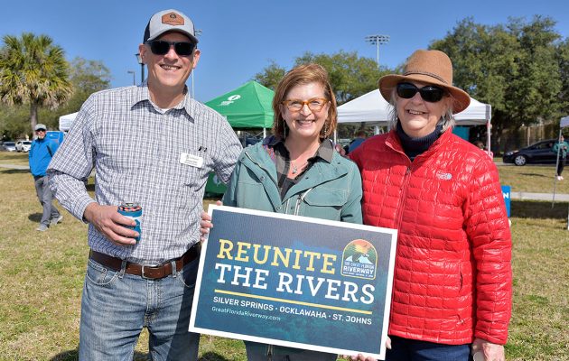 Jimmy Orth, Lisa Rinaman and Marty Jones with a Reunite the Rivers sign